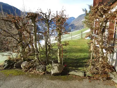 a couple of trees and rocks next to a house at Stofel 2078 in Unterwasser