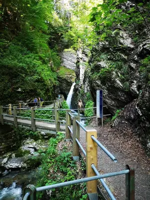 a bridge over a river with a waterfall at Stofel 2078 in Unterwasser