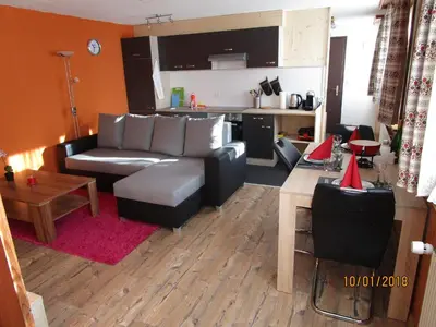 a living room with a couch and a table at Stofel 2078 in Unterwasser