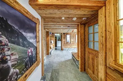a hallway in a log cabin with a mural on the wall at Hotel Landgasthof Eischen in Appenzell