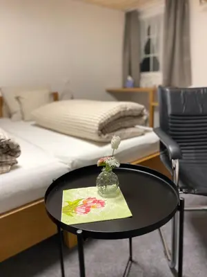 a room with a bed and a table and a bed at Hotel Landgasthaus Neues Bild, Eggerstanden in Appenzell