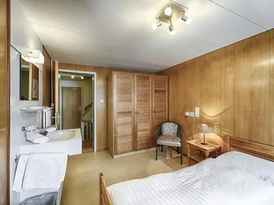 a bedroom with a bed and a sink and a tub at Hotel Weisses Kreuz in St. Gallen