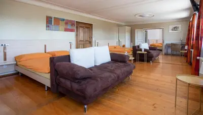 a living room with a couch and a bed at Hotel Rotes Kreuz in Arbon