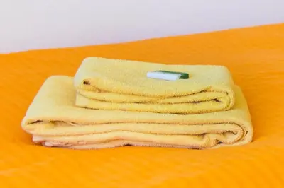 a stack of towels with a cell phone on top at Hotel Rotes Kreuz in Arbon