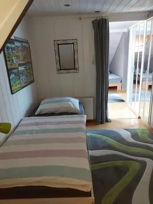 a bedroom with a bed and a balcony at Haus Basilea in Wolfhalden