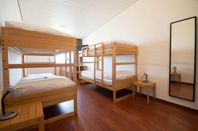 a room with three bunk beds and a mirror at Hotel Bodensee-Arena in Kreuzlingen