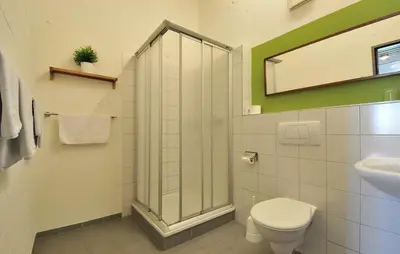 a bathroom with a shower and a toilet and a sink at Hotel Bodensee-Arena in Kreuzlingen