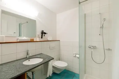 a bathroom with a shower and a toilet and a sink at Schloss Wartegg in Rorschacherberg