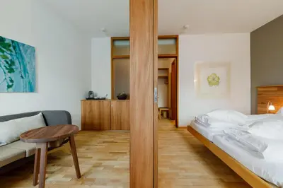 a bedroom with a bed and a table and a couch at Schloss Wartegg in Rorschacherberg