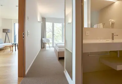 a bathroom with a sink and a mirror at APPADU Appartements in St. Gallen