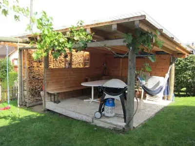 a barbecue grill in a shed in a yard at Ferienwohnung Inauen in Appenzell