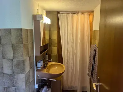 a bathroom with a sink and a shower curtain at Ferienwohnung Inauen in Appenzell
