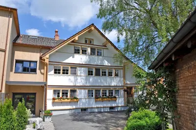a large white house with a lot of windows at Bären - Das Gästehaus in Gais