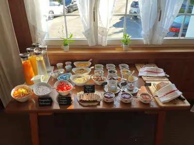 a table with many different dishes of food on it at Bären - Das Gästehaus in Gais