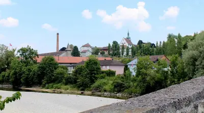a view of a river with a city in the background at Hotel Le Lion - Self Check-in in Bischofszell
