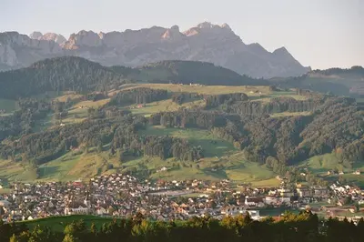 a town on a hill with mountains in the background at Ferienstudio Familie Fässler-Dörig in Appenzell