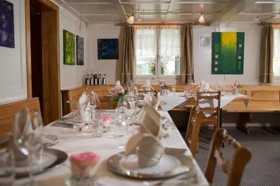 a dining room with tables and chairs with napkins on them at Landgasthaus Bären in Grub