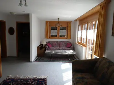 a living room with a purple couch and a window at Gasthaus Schäfli in Alt Sankt Johann