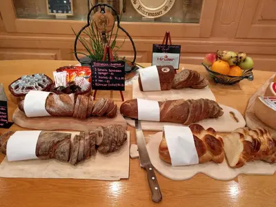 a table with several different types of bread and croissants at Gasthaus Schäfli in Alt Sankt Johann