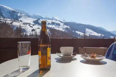 a bottle of wine sitting on a table with a glass at Hotel Restaurant Schönau in Wildhaus