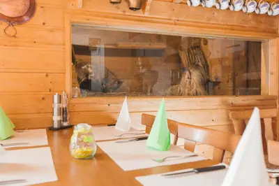 a dining room with a table and a window at Hotel Restaurant Schönau in Wildhaus