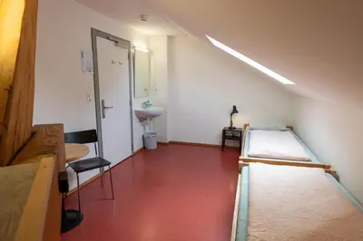 a hospital room with two beds and a sink at Kreuzlingen Youth Hostel in Kreuzlingen