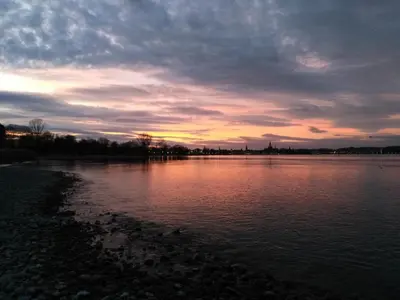 a sunset over a large body of water at Studio zum Wohlfühlen in Kreuzlingen