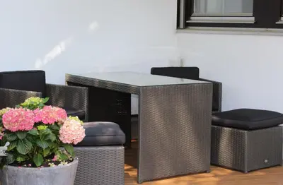 a table and chairs with flowers in a room at Studio zum Wohlfühlen in Kreuzlingen