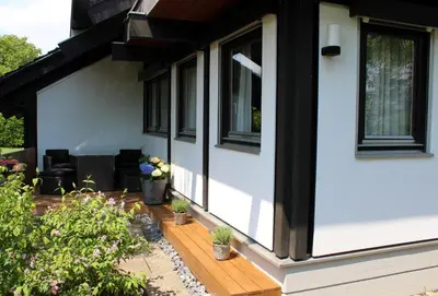 a front porch of a house with potted plants at Studio zum Wohlfühlen in Kreuzlingen