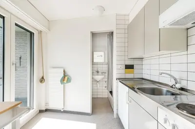 a kitchen with white cabinets and a sink at SOHO 2A !Gratis Parken, Free Parking! in Kreuzlingen