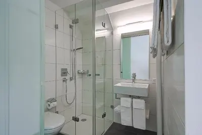 a bathroom with a shower and a sink and a toilet at Gasthof Eisenbahn in Weinfelden