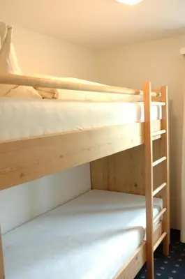 two bunk beds in a small room with a ladder at Landgasthof Sternen in Bühler