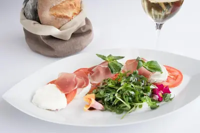 a table topped with lots of different types of bread at Hotel Stump's Alpenrose in Wildhaus
