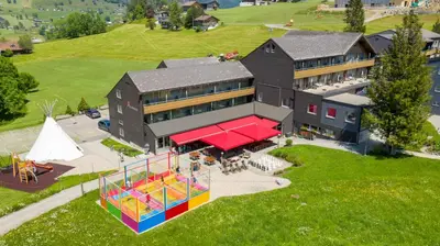 an aerial view of a building with a playground at Hotel Stump's Alpenrose in Wildhaus