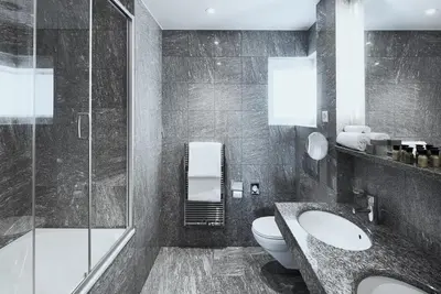 a bathroom with a toilet and a sink and a shower at Hotel Uzwil in Uzwil