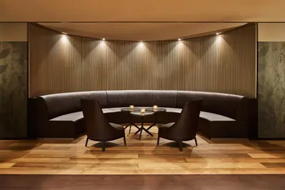 a dining room with a couch and a table at Hotel Uzwil in Uzwil