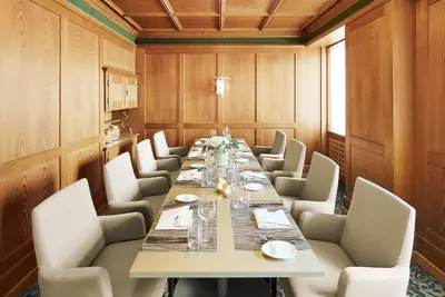 a large dining room with a long table and chairs at Hotel Uzwil in Uzwil