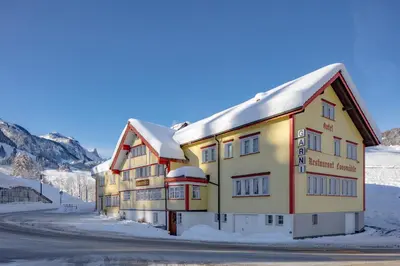 a building with snow on top of it at Loosmühle in Weissbad
