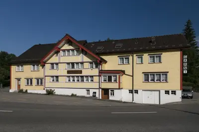 a large building on the side of a street at Loosmühle in Weissbad