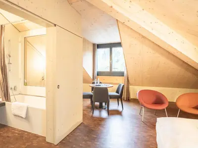 a room with a table and chairs in a room at Lodge Hof Weissbad in Weissbad