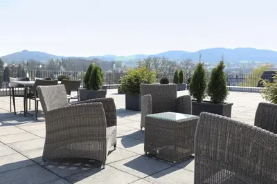 a group of chairs and tables on a patio at Uze Apartments in Uzwil SG in Uzwil