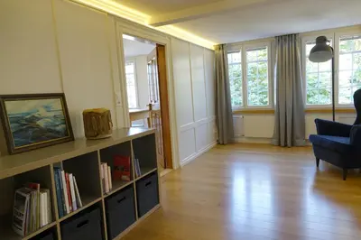 a living room with a book shelf with books at Haus zur Rose, St.Gallen, Bodensee, Säntis in Speicher