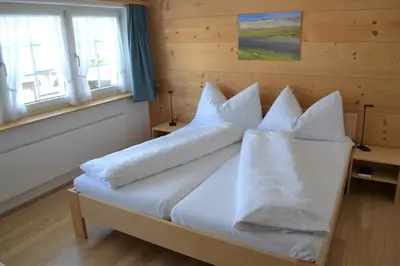 a bedroom with a bed with white sheets and pillows at Gasthaus Löwen in Hemberg