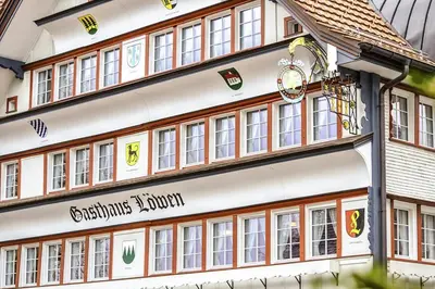 a building with a sign on the side of it at Gasthaus Löwen in Hemberg