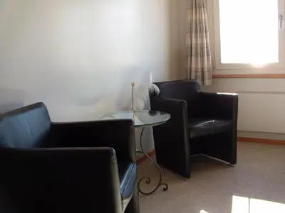 a waiting room with two chairs and a table at Gasthaus Bären Schlatt in Appenzell