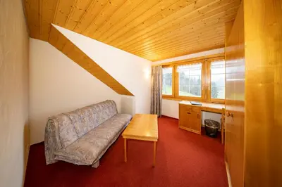 a living room with a couch and a table at Hotel und Restaurant Chäseren in Schönengrund