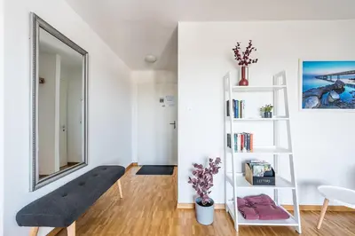 a room with a bench and a mirror at SOHO 8 !Lake-Mountain View & Free Parking! in Kreuzlingen