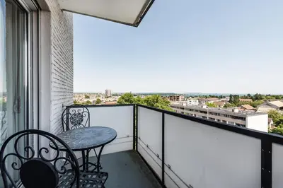 a balcony with a table and chairs and a view at SOHO 8 !Lake-Mountain View & Free Parking! in Kreuzlingen