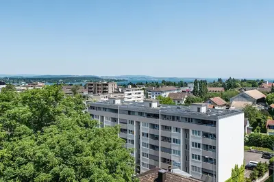 an aerial view of a building in a city at SOHO 8 !Lake-Mountain View & Free Parking! in Kreuzlingen