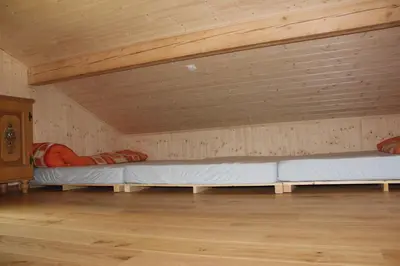 a room with two beds in a attic at Chalet Nueschwendi in Ebnat